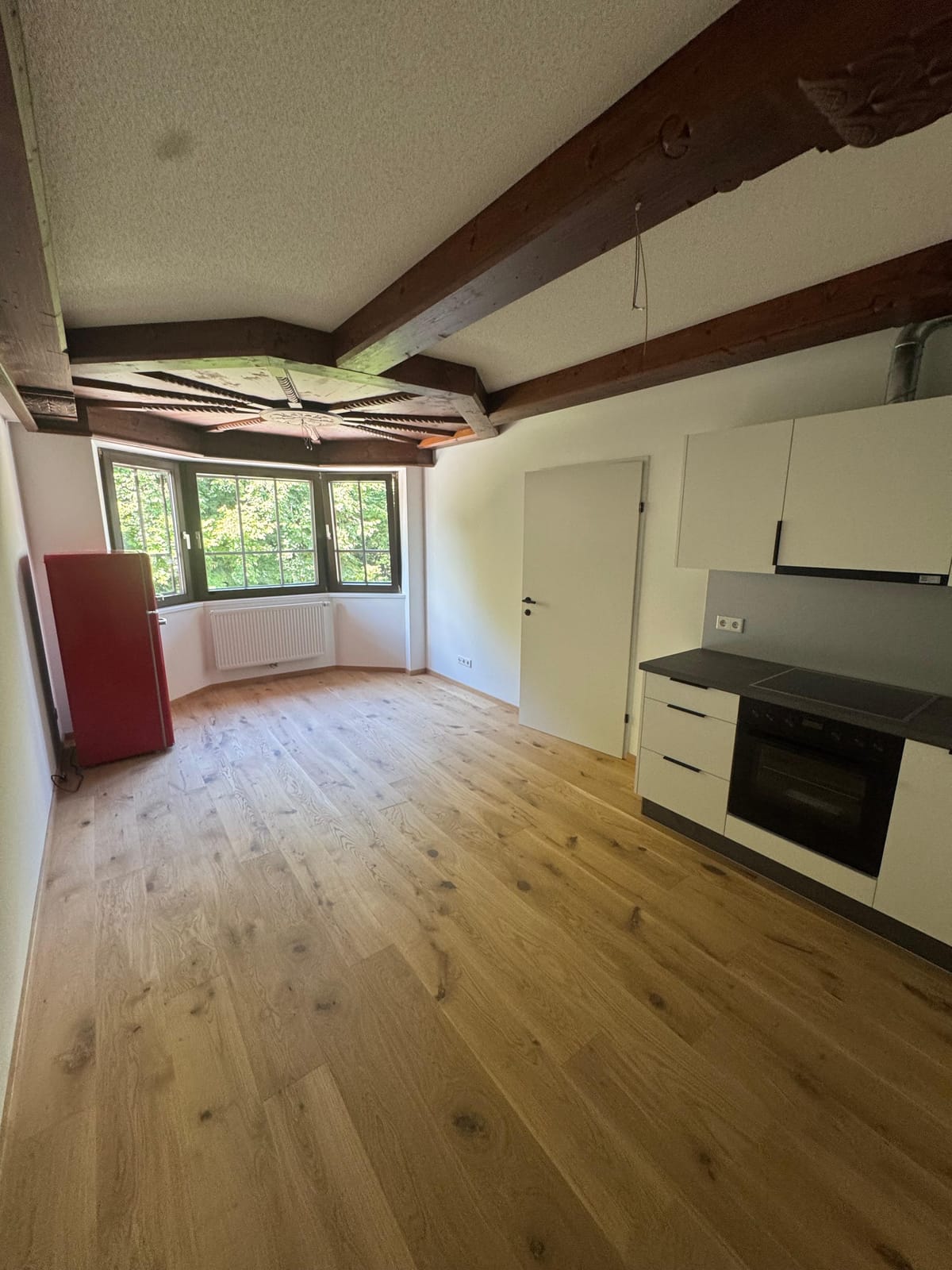 Wohnküche der sanierten Wohnung in Kufstein mit Einbauküche und Erker